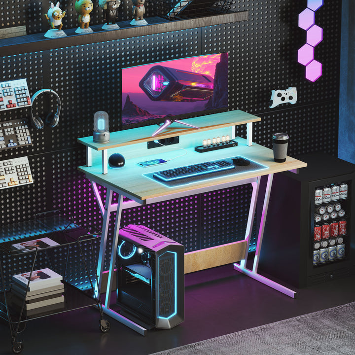 Secretária Gaming com Luzes LED 100x60x88,5 cm Mesa Gaming com Tomadas de Corrente Suporte para Monitor Prateleiras e Controlo Remoto para Escritório Estúdio Madeira