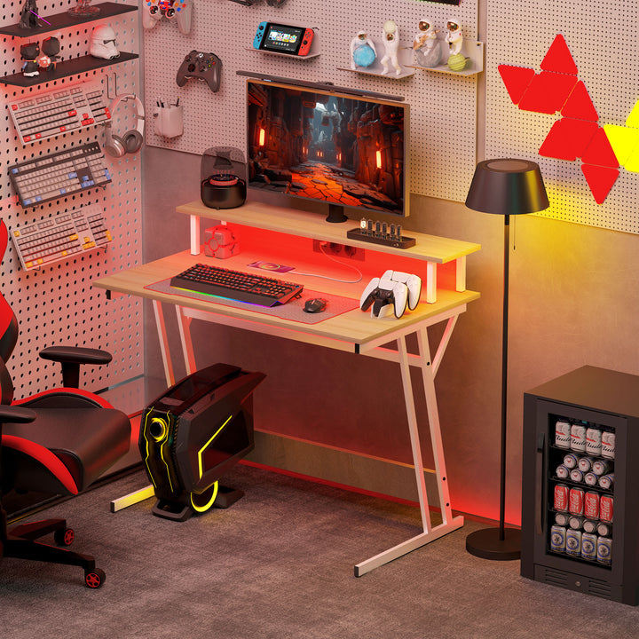 Secretária Gaming com Luzes LED 100x60x88,5 cm Mesa Gaming com Tomadas de Corrente Suporte para Monitor Prateleiras e Controlo Remoto para Escritório Estúdio Madeira